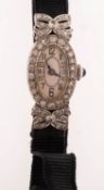 An Art Deco platinum and diamond lady's cocktail watch the oval silvered dial having black Arabic