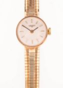 Longines a 9K gold lady's wristwatch the round cream dial having raised baton numerals,