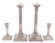 Two pairs of silver plated candlesticks,