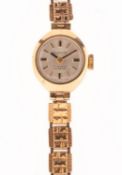 Everite a 9K gold lady's wristwatch the round silvered dial having raised baton numerals,