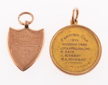 Two 9ct gold golf related medallions, a 9ct gold shield shaped medallion,