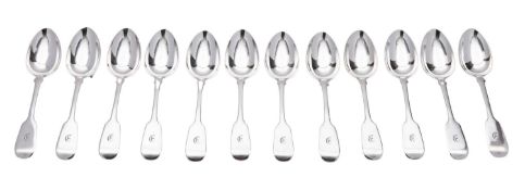 A Victorian set of twelve West Country provincial silver dessert spoons, Fiddle pattern, initialled,