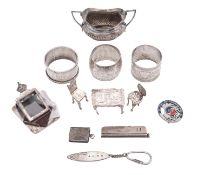 A mixed lot of silver, to include 3 napkin rings, a racing pin brooch (Test International,