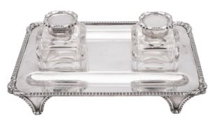 A George V silver inkstand, of rounded rectangular outline,