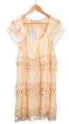 Stella McCartney, A cream silk mini dress with cut-out tiered layers to the body and shoulders,