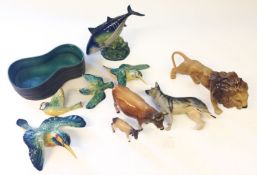 A collection of Beswick figures. Including birds, lion, Jersey Bull, Jersey calf and fish etc.