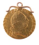 A 1787 George III Guinea coin. With yellow metal mount.