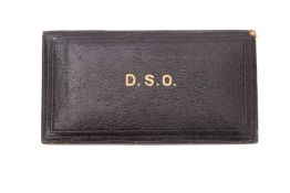A Garrard & Co DSO medal case. In black leather with gold lettering and purple velvet interior.