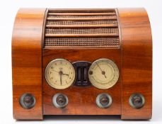An early 20th century Goblin clock radio, circa 1947, in a walnut case with brown Bakelite fittings,