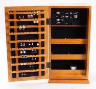 A quantity of various costume jewellery within g a mirrored cabinet.