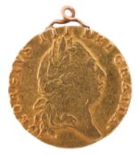 A 1793 George III Guinea coin. With yellow metal mount.