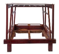 A late 19th/early 20th century Chinese red lacquer chinoiserie doll's bed,