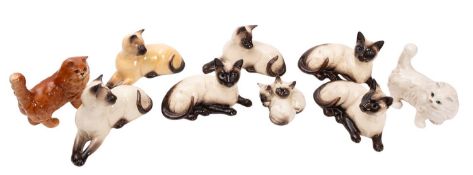 A collection of nine Beswick cats. Including Siamese examples etc.