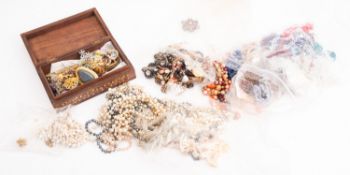 An accumulation of various costume jewellery mostly necklaces and brooches.