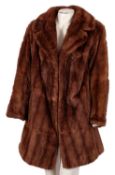 A 20th Century brown mink fur coat. With silk lining, 42cm wide.
