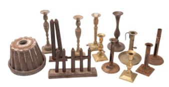 A group of various brass candlesticks, together with two candle moulds and a dessert mould etc.