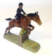 A Beswick Huntswoman, shown jumping a fence, 25cm high.