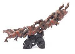 A Chinese carved wood group of seven run