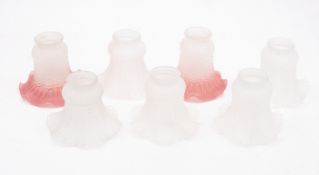A set of seven moulded glass light shades, 20th century, with dimpled exteriors and flared rims,