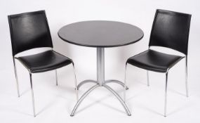 A bistro table and twin chairs, modern;