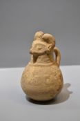 A Western Asian Pottery Human-head Handled Jar, Neolithic Period