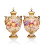 A pair of Royal Worcester porcelain pedestal two-handled vases and covers By Harry Ayrton and Jo...