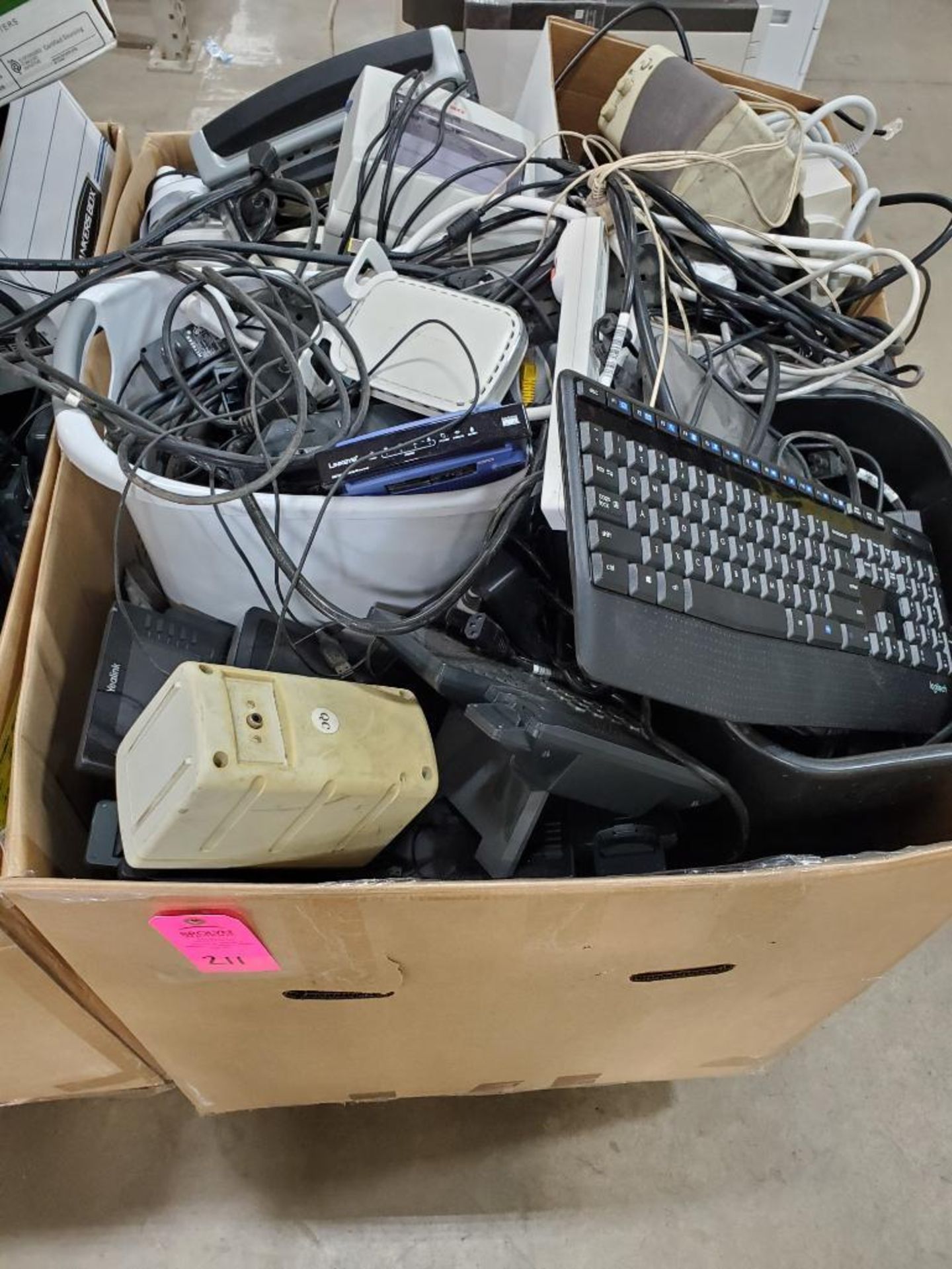 Box of assorted computers peripherals.