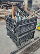 Crate of assorted brooms and shovels.