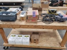 Table with contents. Tools, hot knife, supplies, etc.