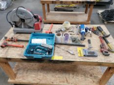 Table with contents. Milwaukee cold saw, hand tools, etc.