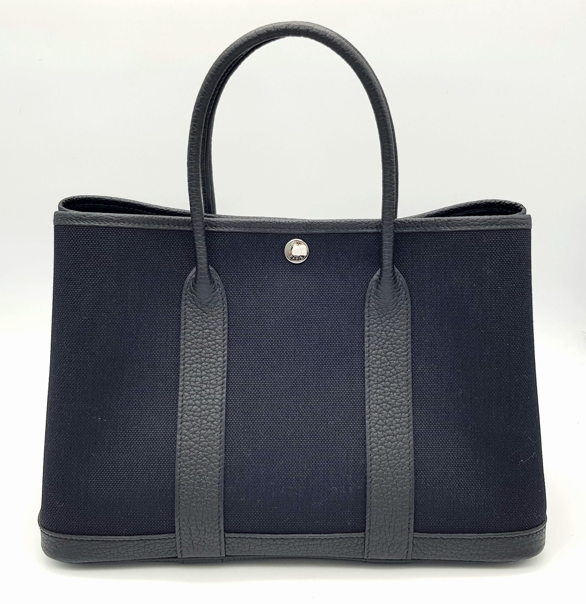 A Hermès Garden Party 30 Black Canvas and Leather Tote Bag. Black canvas exterior with black