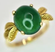 AN 18K GOLD DESIGNER RING WITH A CENTRAL JADE CABOCHON CLAW SET . 4.3gms size O