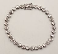 An 18K WHITE GOLD DIAMOND SET TENNIS BRACELET, APPROX 2CT DIAMONDS 14.6G. Ref: SPSA 7001