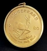 A KRUGERRAND COIN DATED 1980 - 1 OZ OF FINE GOLD (22K) IN A 9K GOLD PENDANT SETTING. KRUGERRAND