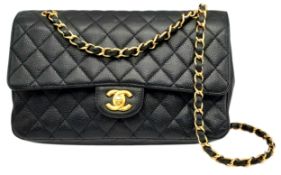 A Chanel Black Caviar Leather Classic Double Flap Bag. Black caviar leather exterior with gold-toned