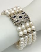 A FOUR ROW AKOYA PEARL BRACELET WITH A 14K WHITE GOLD DIAMOND AND SAPPHIRE SET CLASP. A BEAUTIFUL