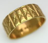 A 22K GOLD BAND RING WITH THE X FACTOR DECORATION . 5.3gms size J