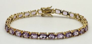 A 2015 Hallmarked gilded Sterling Silver Amethyst Set Tennis Bracelet-18.5cm Length. Set with