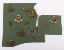 Grouping of Middlesex Regiment Cap Badges & Shoulder Titles.