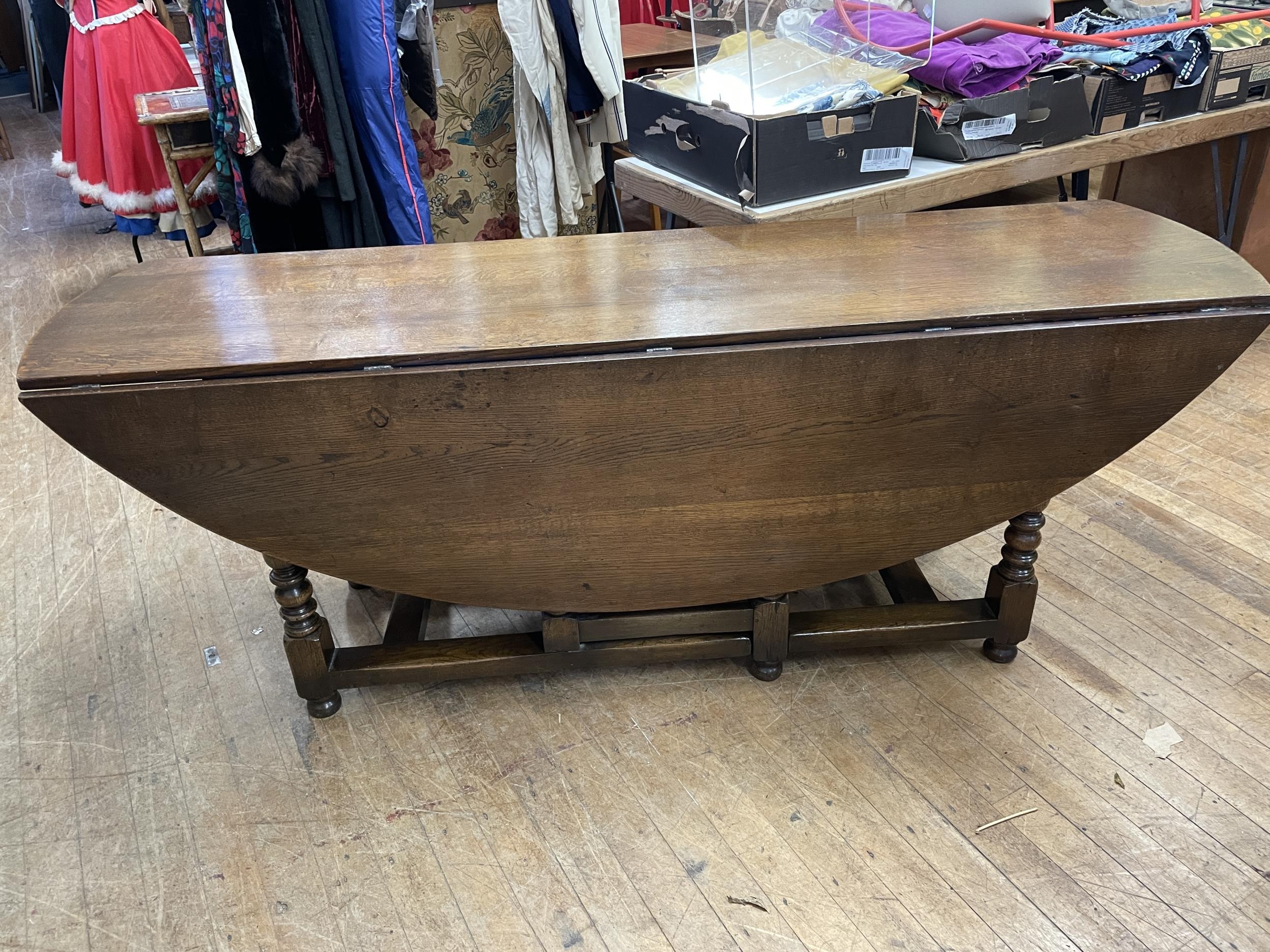 An oak drop leaf dining or wake table, 210 cm wide