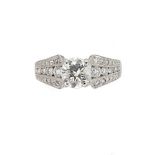 A single stone diamond ring with diamond set shoulders,
