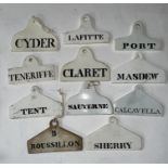 A collection of 11 Victorian white glazed ceramic wine bin labels,