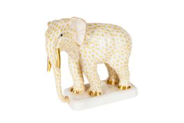 A HEREND PORCELAIN BUTTERSCOTCH FISHNET MODEL OF AN ELEPHANT