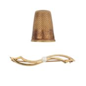 A thimble and a pearl brooch