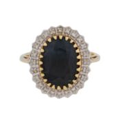 A sapphire and diamond halo ring