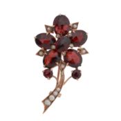 A garnet and seed pearl flower brooch