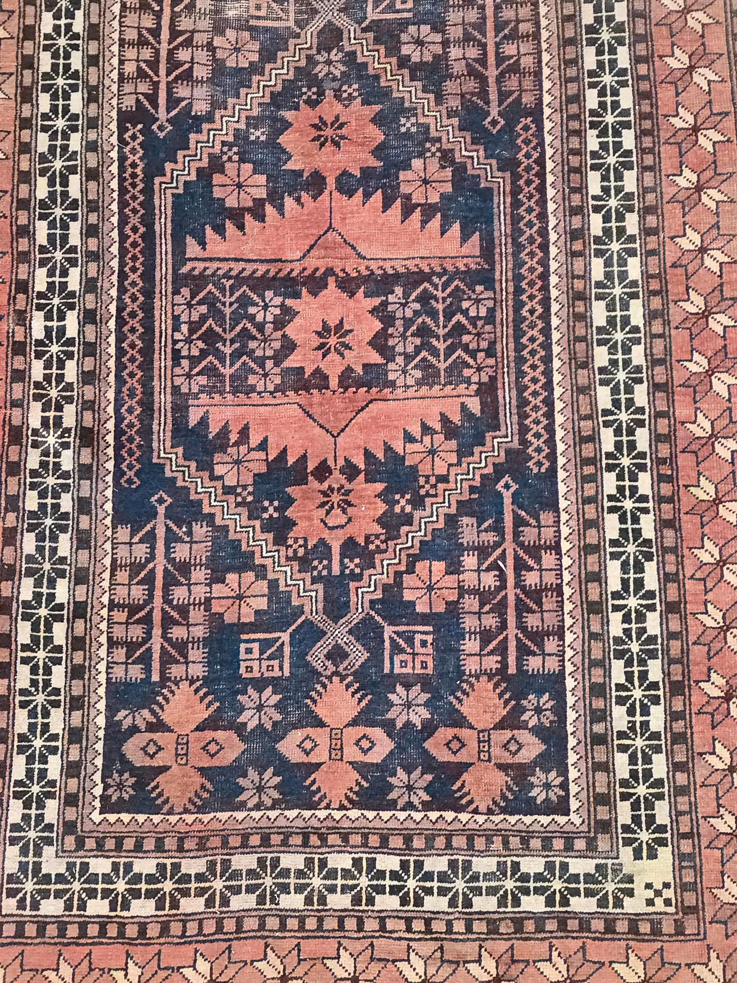 A Persian Baluch rug with geometric pattern on a red ground, 110 by 180cms. - Image 2 of 4