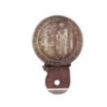 A vintage car badge depicting St Bartholomew.