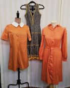 A cotton orange mini dress labelled Alastair Gowan with white saddle stitching and white Peter Pan