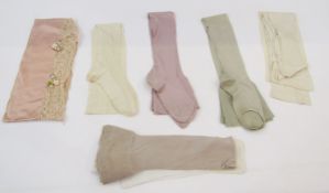 Six pairs of 1920's/'30's silk stockings, sage green, mauve, cream and fawn, within a satin and lace